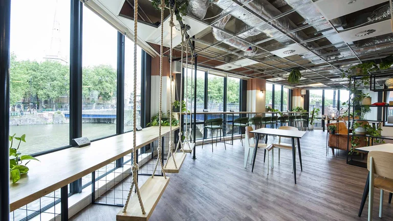 The inside of 1 Victoria Street with large windows and swings