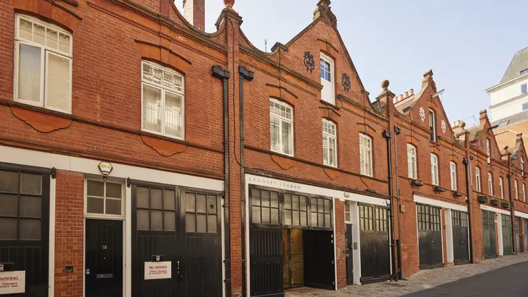 A row of houses with garages on the ground floor 