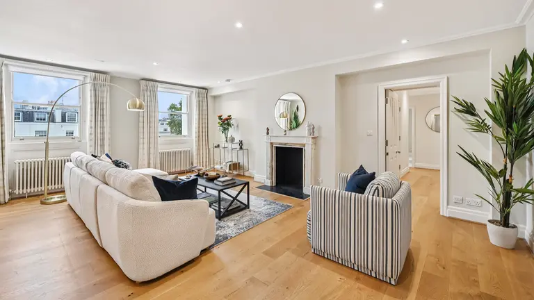 Living room with sofa, armchair and fireplace