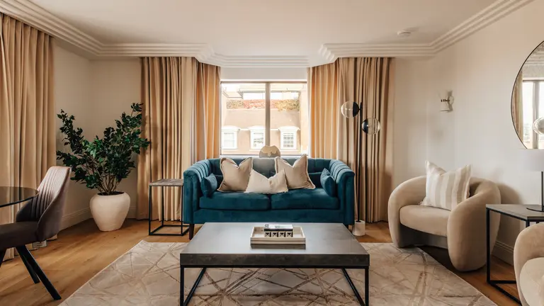A living room with a sofa, armchairs and a coffee table 