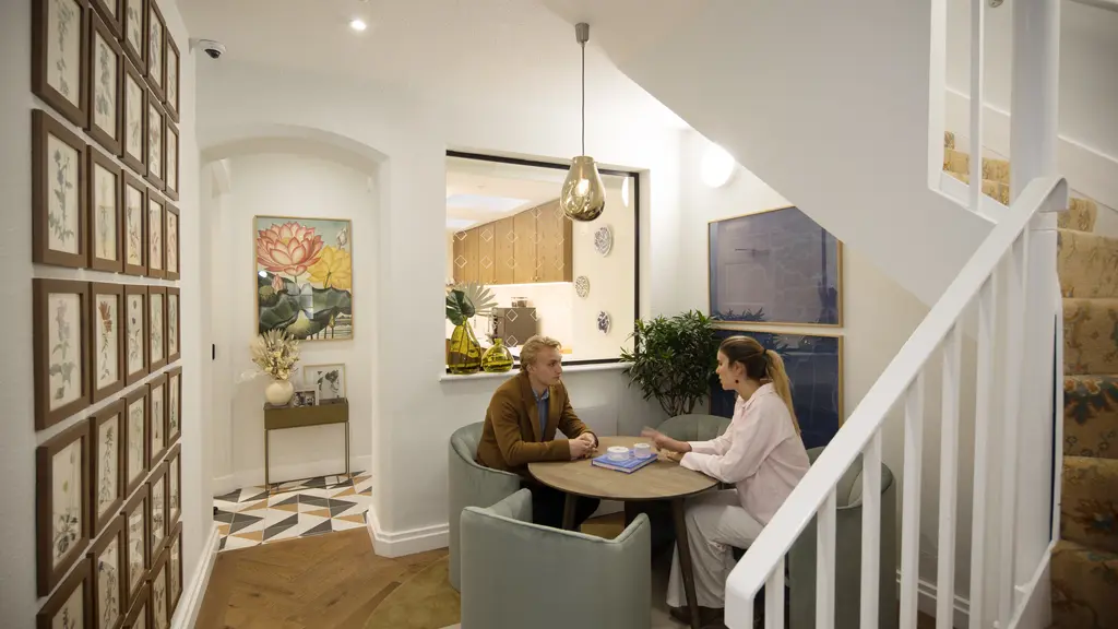 Two people talking in a kitchen