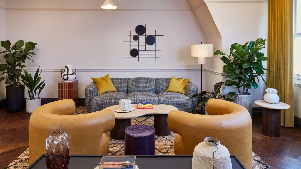 Social area with a large sofa, coffee table, and two arm chairs.