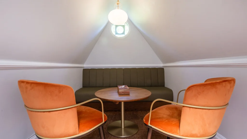Two orange chairs and a table