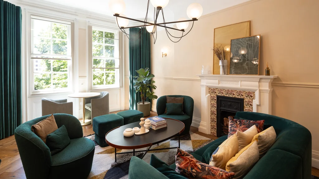 A green sofa and green chairs 