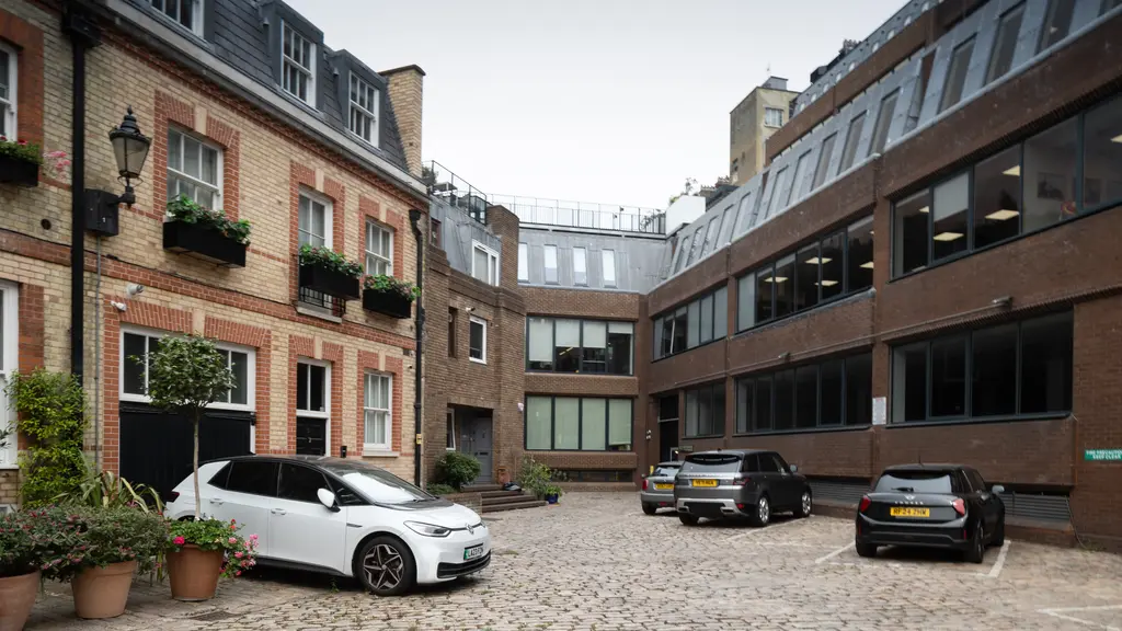 Three cars parked in a mews
