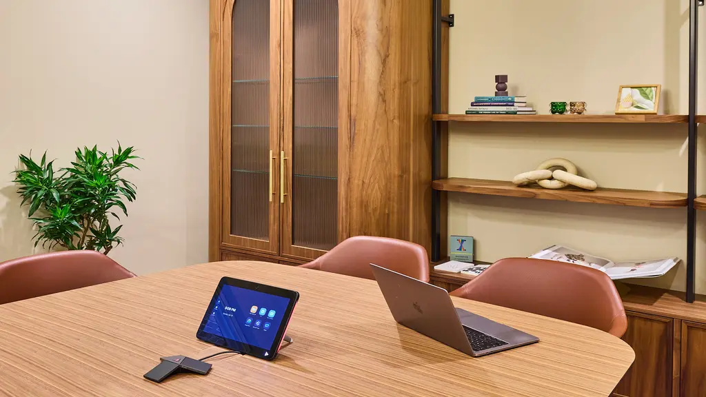 Meeting room with a table, chairs and cupboard 