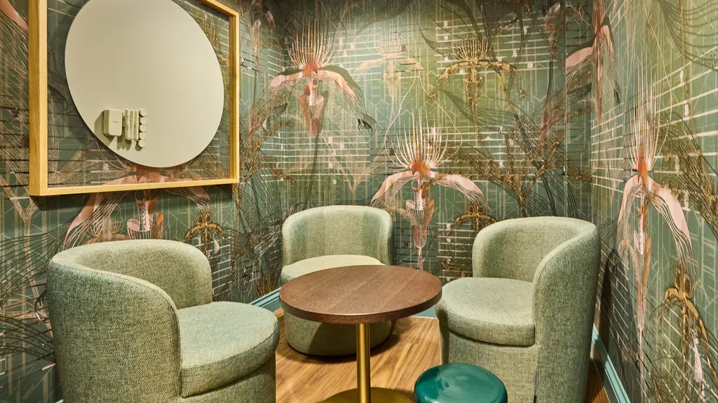 A small meeting room with three chairs 