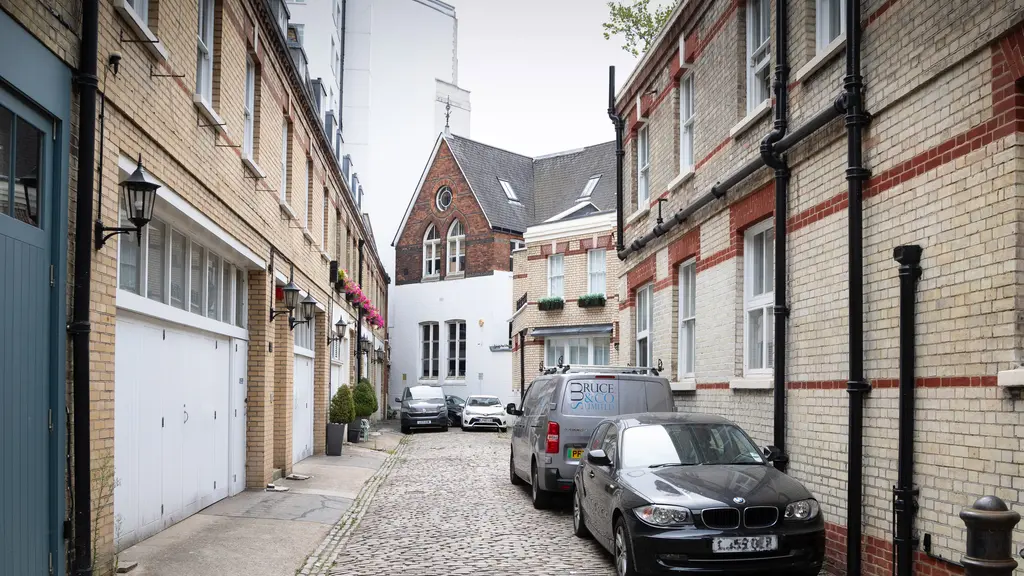 Cars parked down a mews