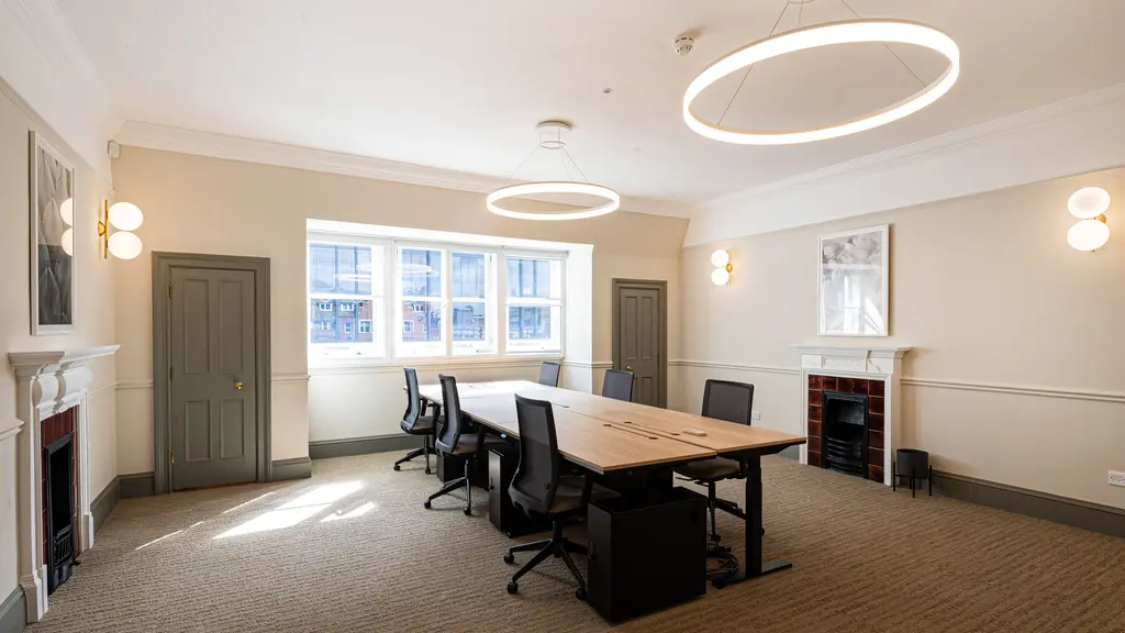 Office with a table, chairs and fireplace