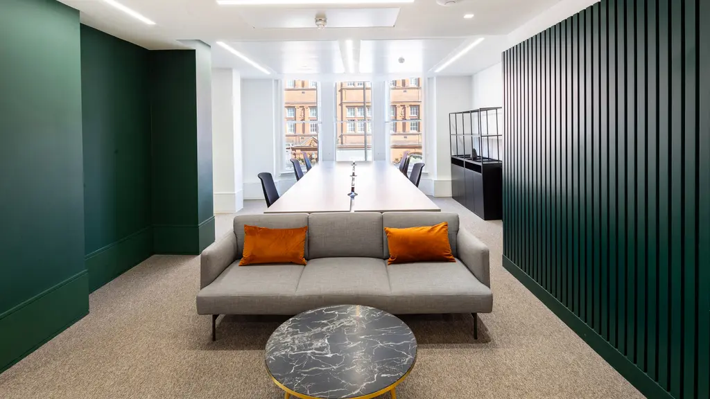 Office space with sofa, desks and chairs