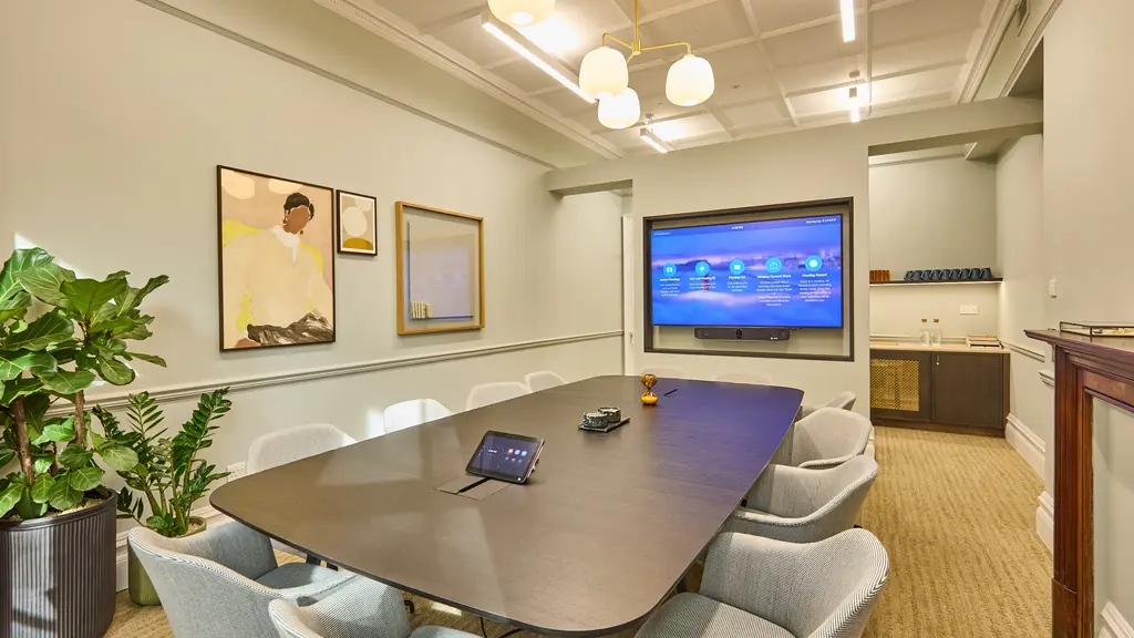 Chairs and a table facing a TV screen