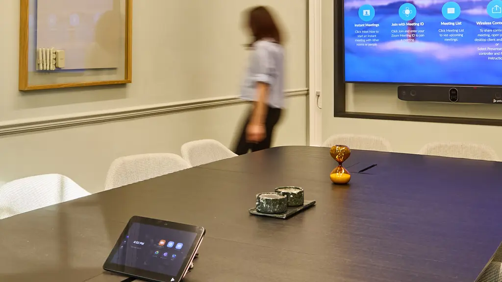 A table and chairs facing a TV screen