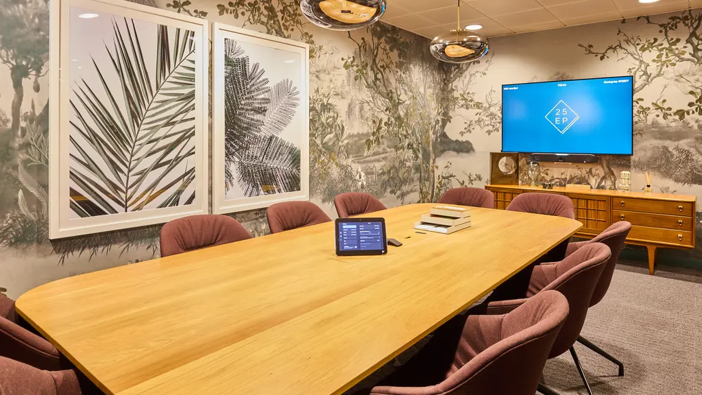 Meeting room with a table, chairs, and artwork