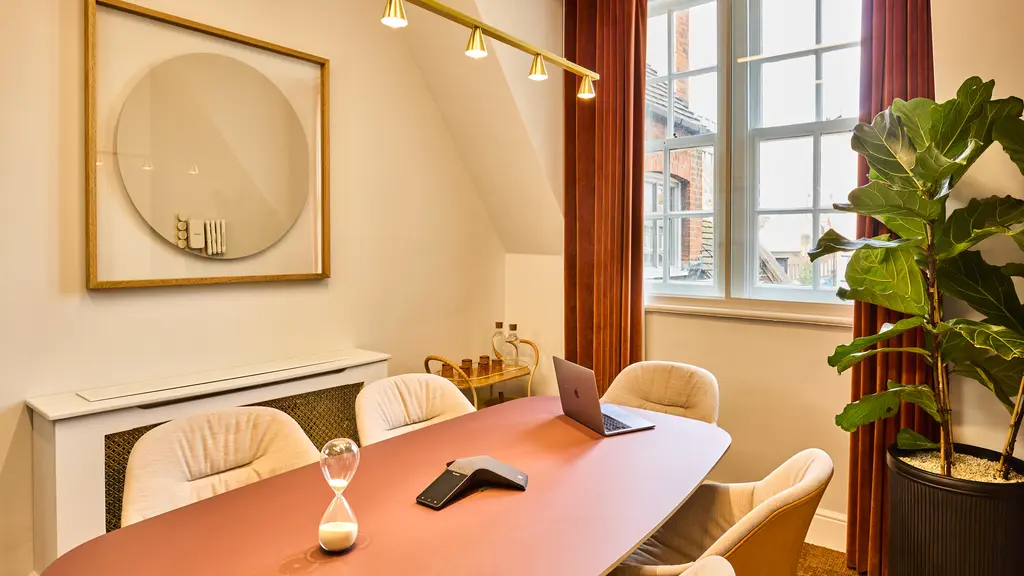 A meeting room with a table and chairs