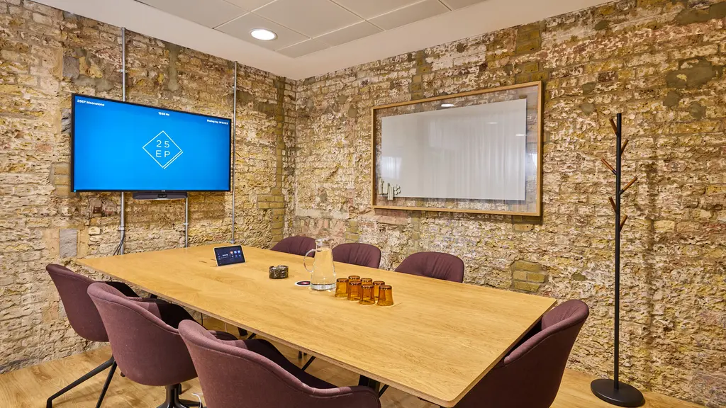 A meeting room with a table and chairs