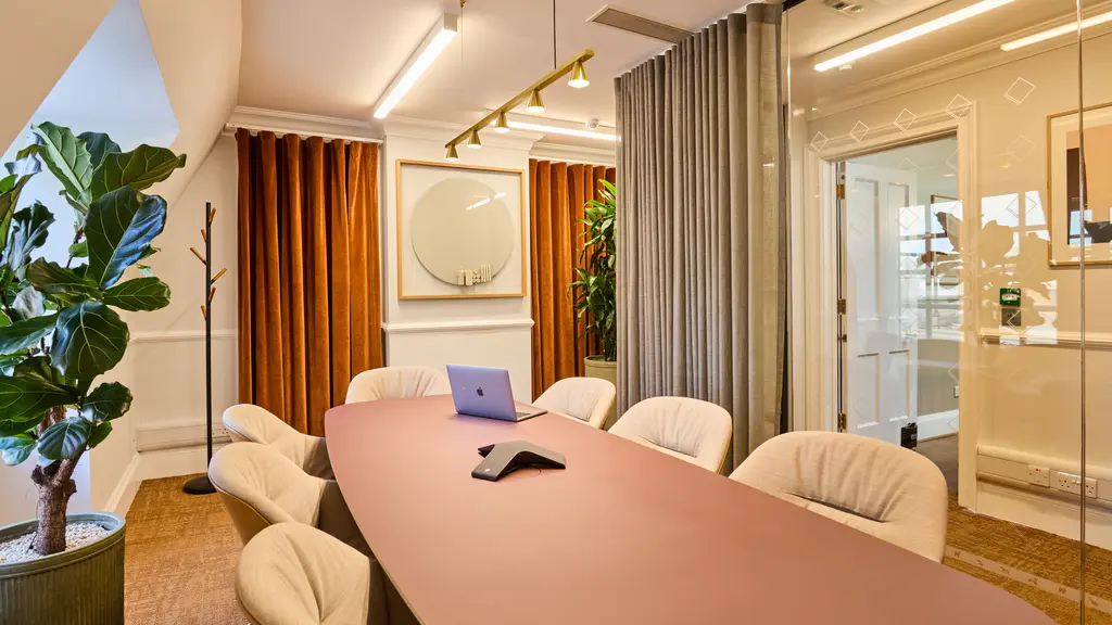 A meeting room with a pink table 