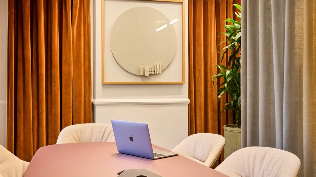 A meeting room with a pink table 