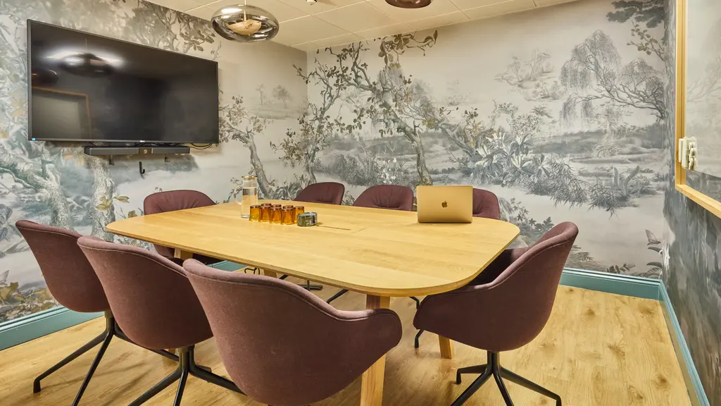 A meeting room with a TV screen