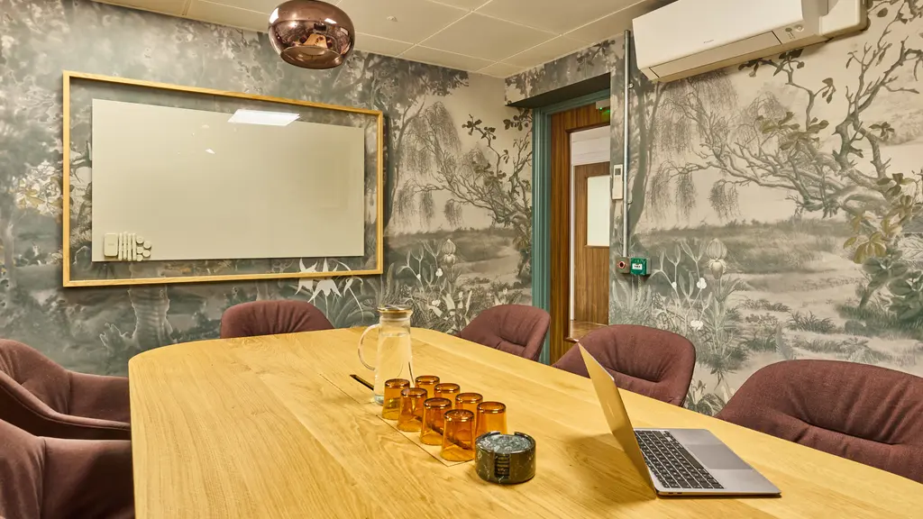A meeting room with a whiteboard