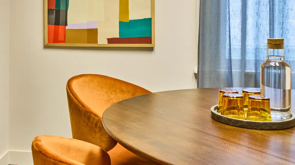 A meeting room with a circular table and four chairs