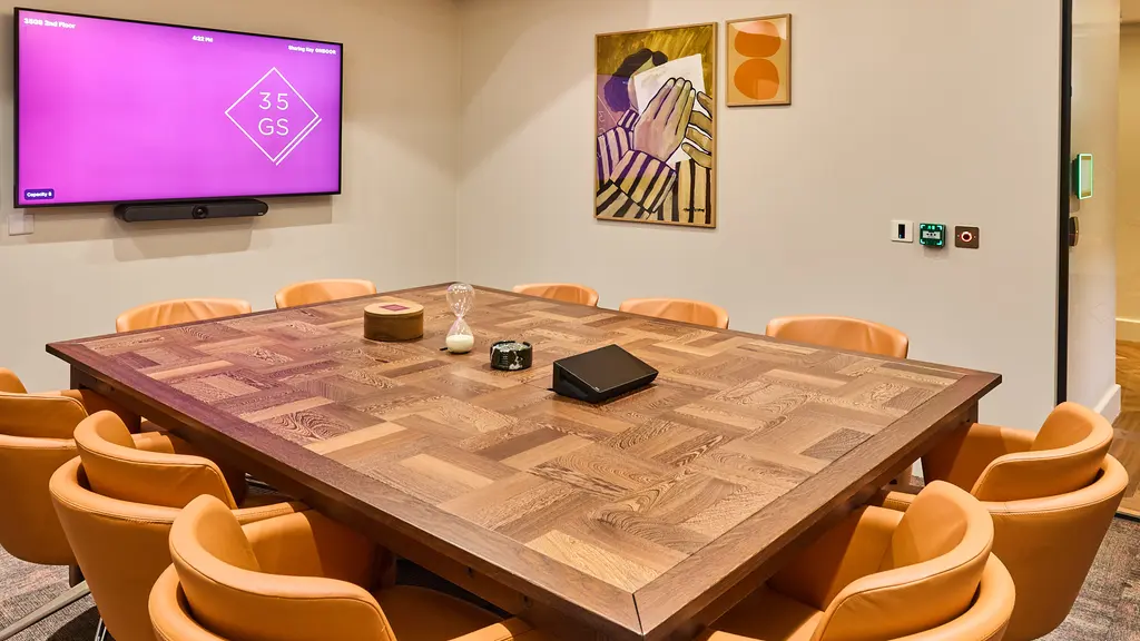 A meeting room with a screen