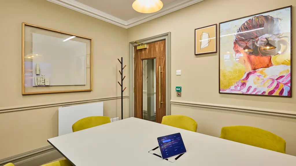 Meeting room with a whiteboard and artwork