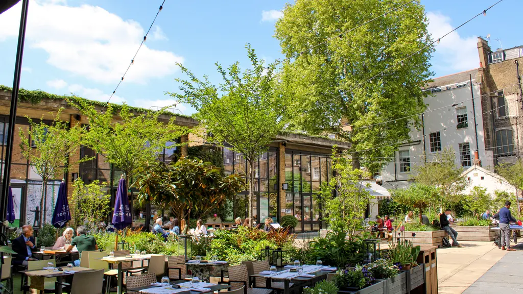 A courtyard with alfresco dining and trees
