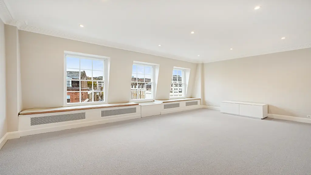 Large empty room with three windows 