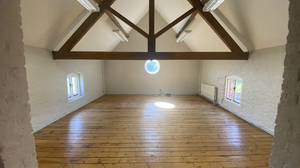 Large room with sloping ceiling