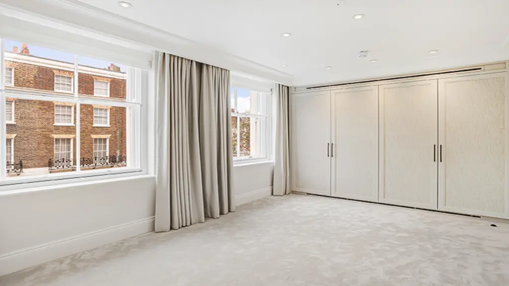 Empty room with built-in storage cupboards