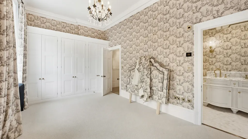Large empty room with fitted cupboards