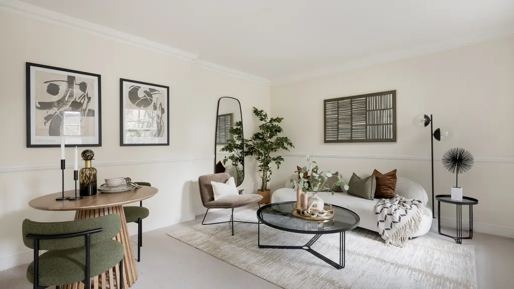 Living room furnished with sofa, dining table and pictures on the wall 