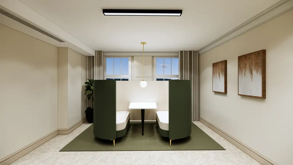 Booth with two chairs and paintings on the wall 