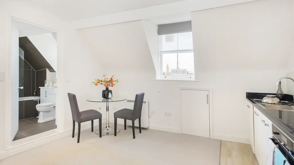 Studio apartment with table and chairs