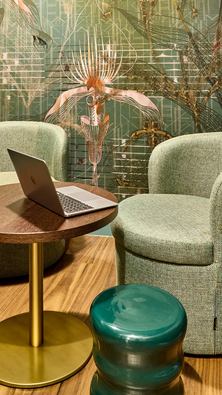 Two chairs and a table with a laptop