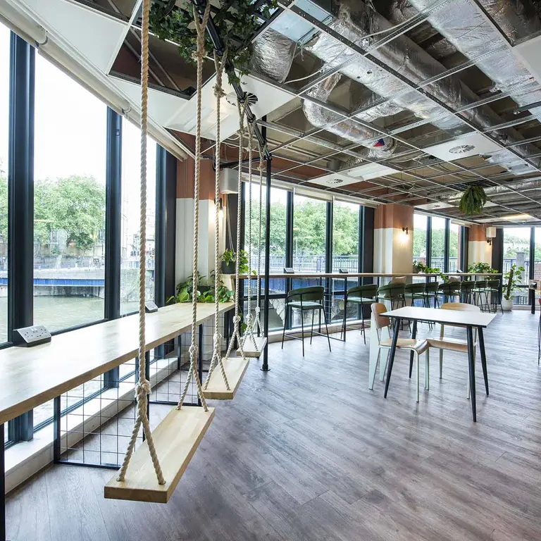 The inside of 1 Victoria Street with large windows and swings