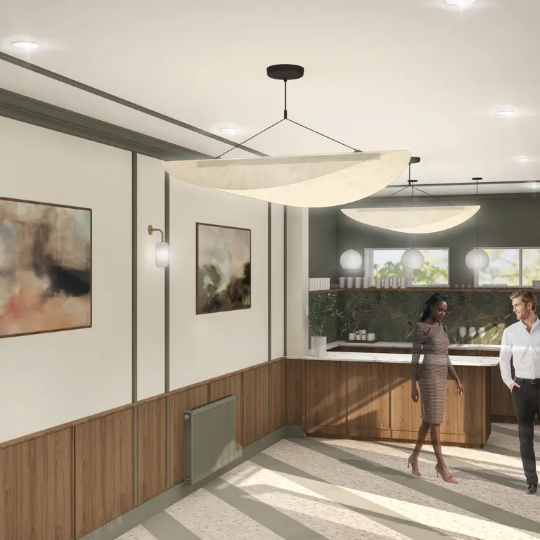 An empty room with two people walking around it 